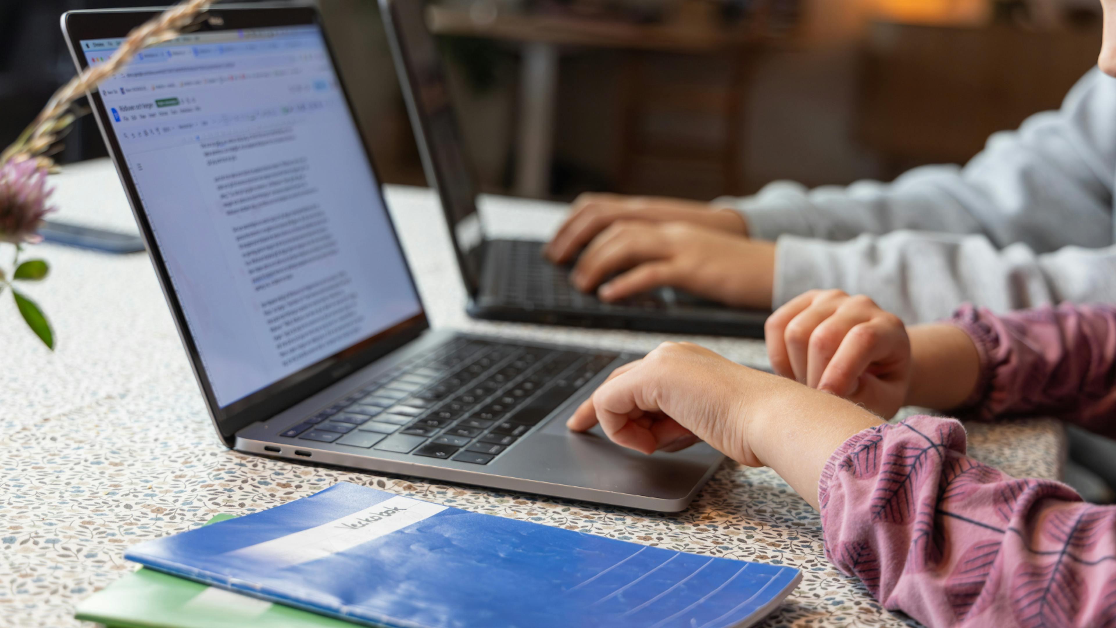 close up photo of two laptops that children are using