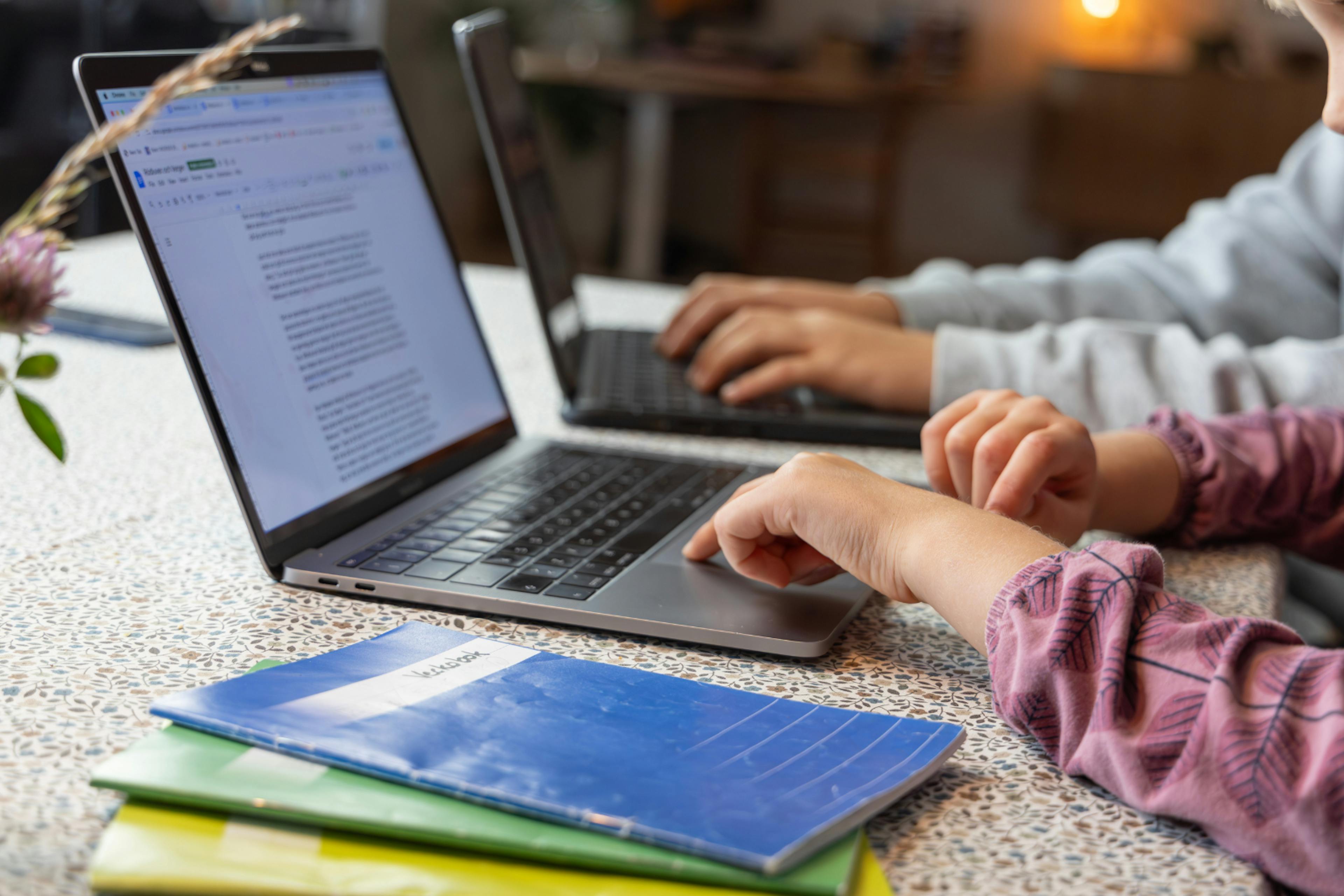 close up photo of two laptops that children are using