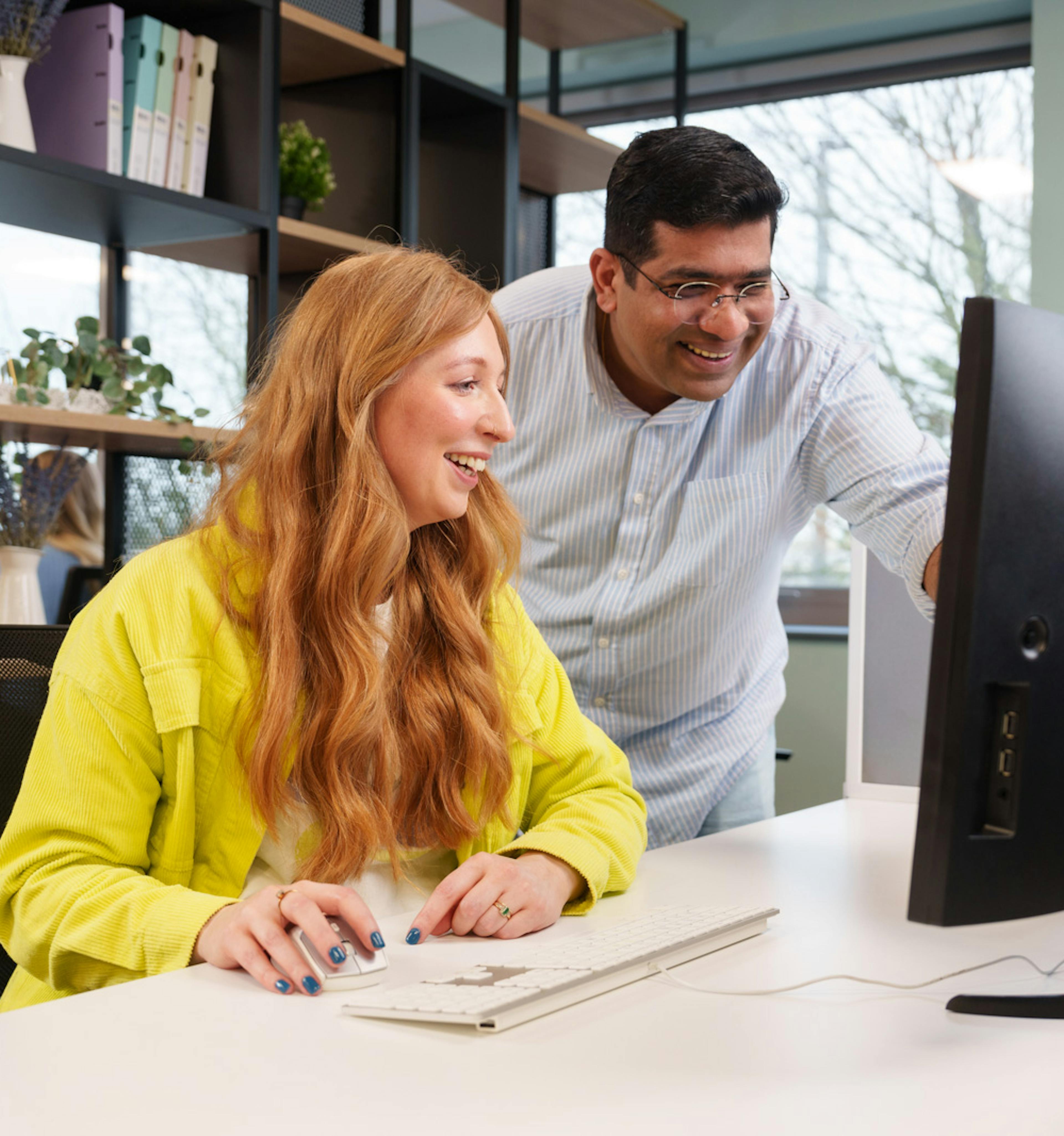 a man pointing at something on a computer screen