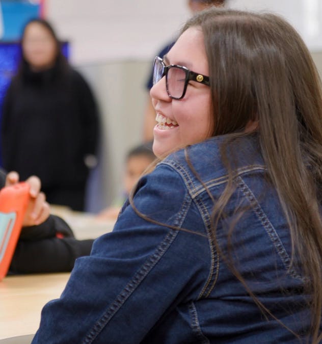 A student in a busy classroom