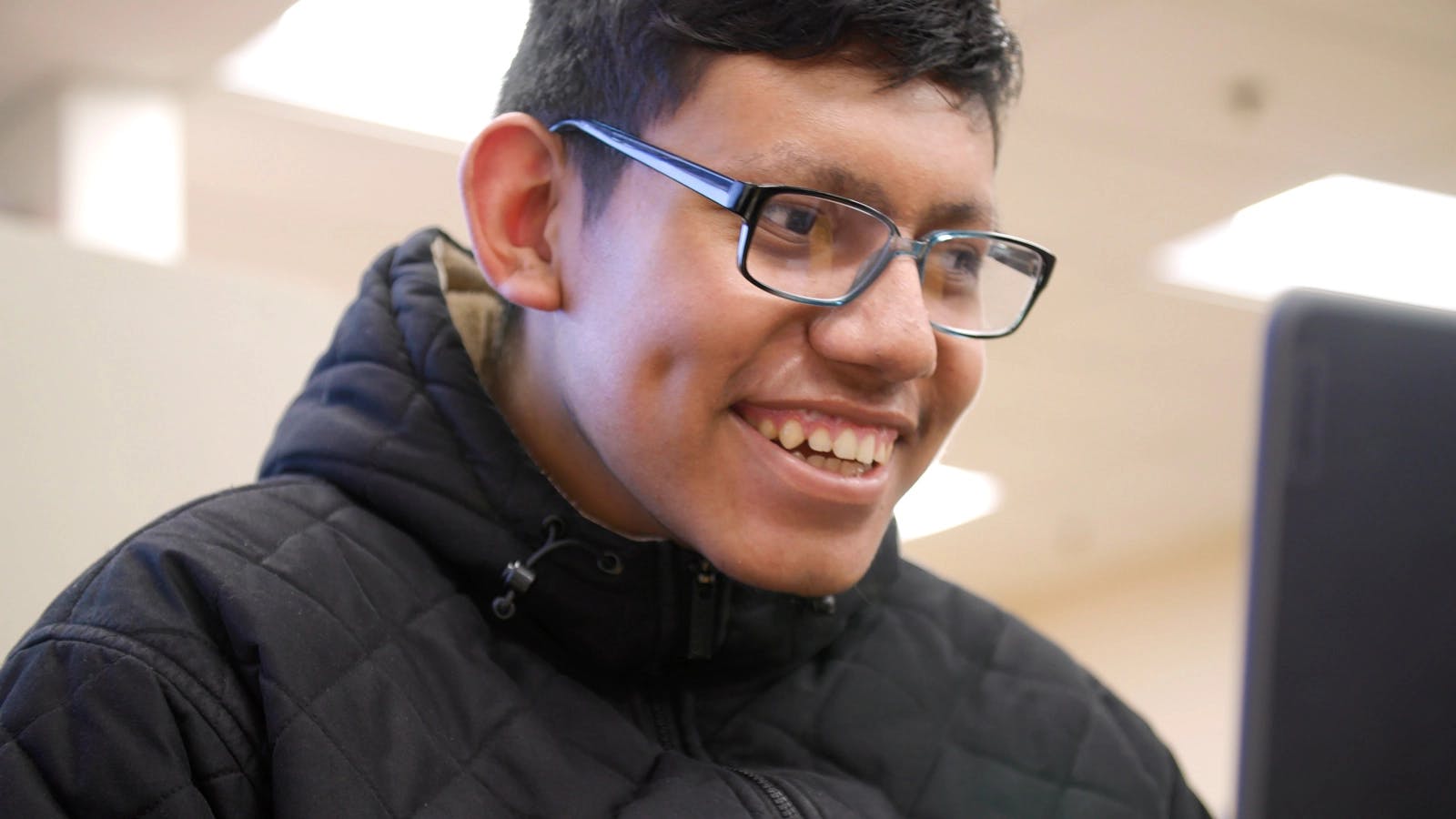 A close up of a student with glasses