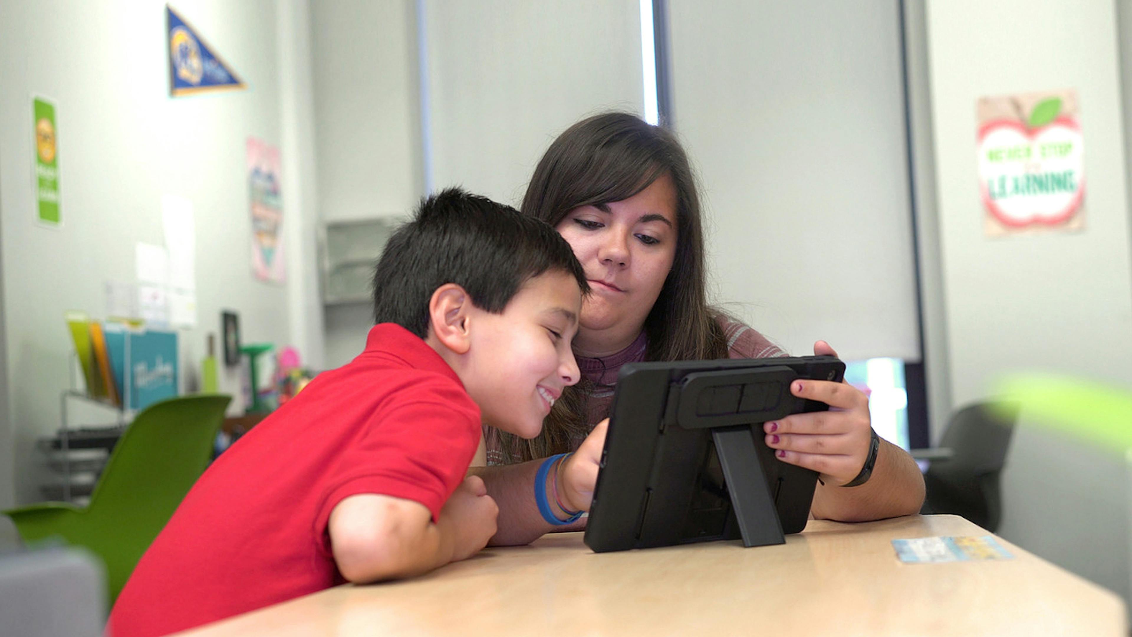 Student and Teacher working together on tablet