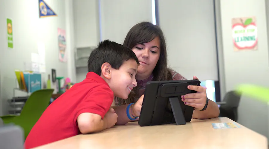 Student and Teacher working together on tablet