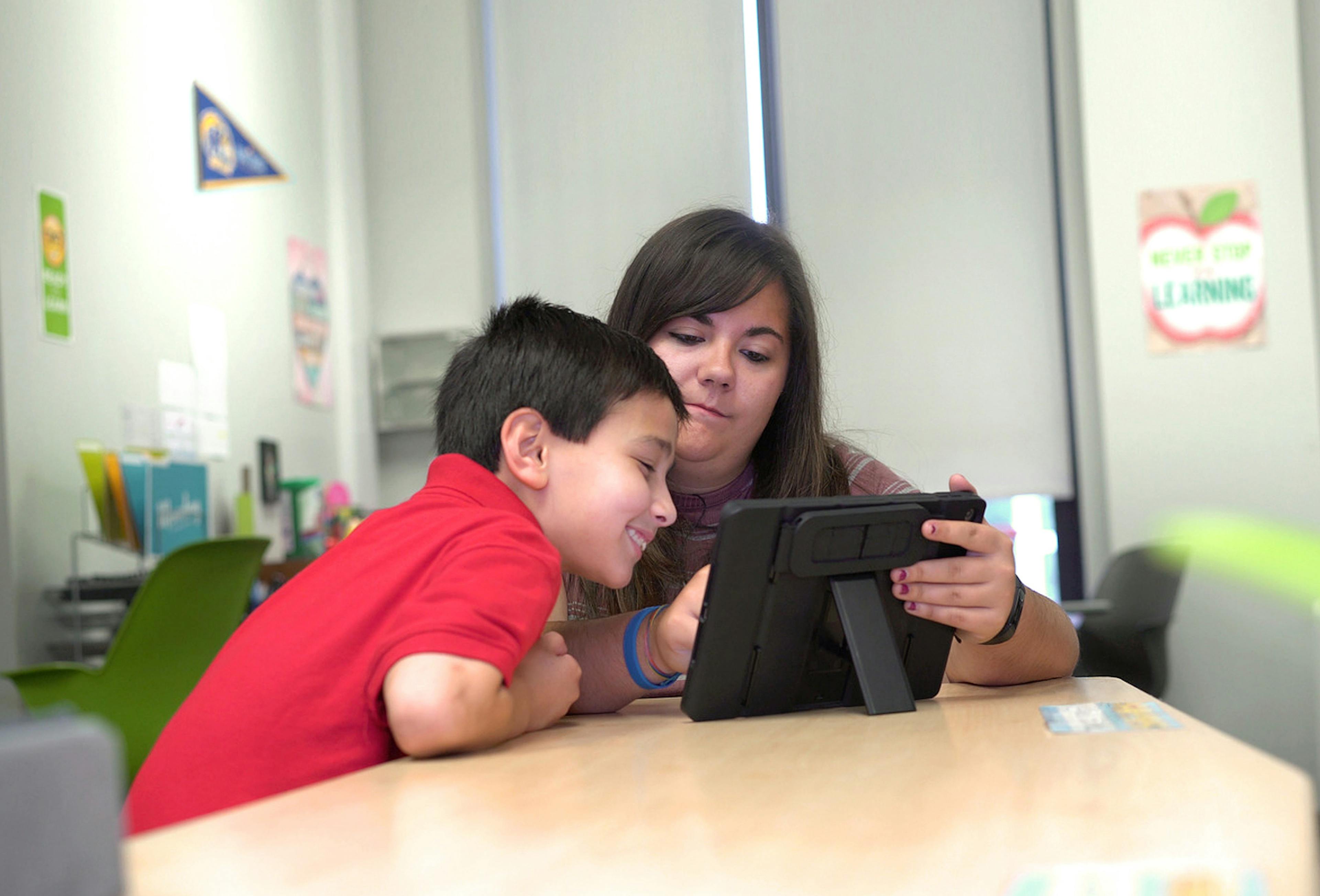 Student and Teacher working together on tablet