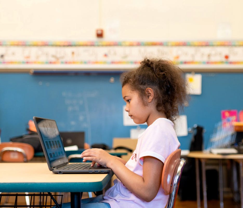 Student working on a laptop in a classroom