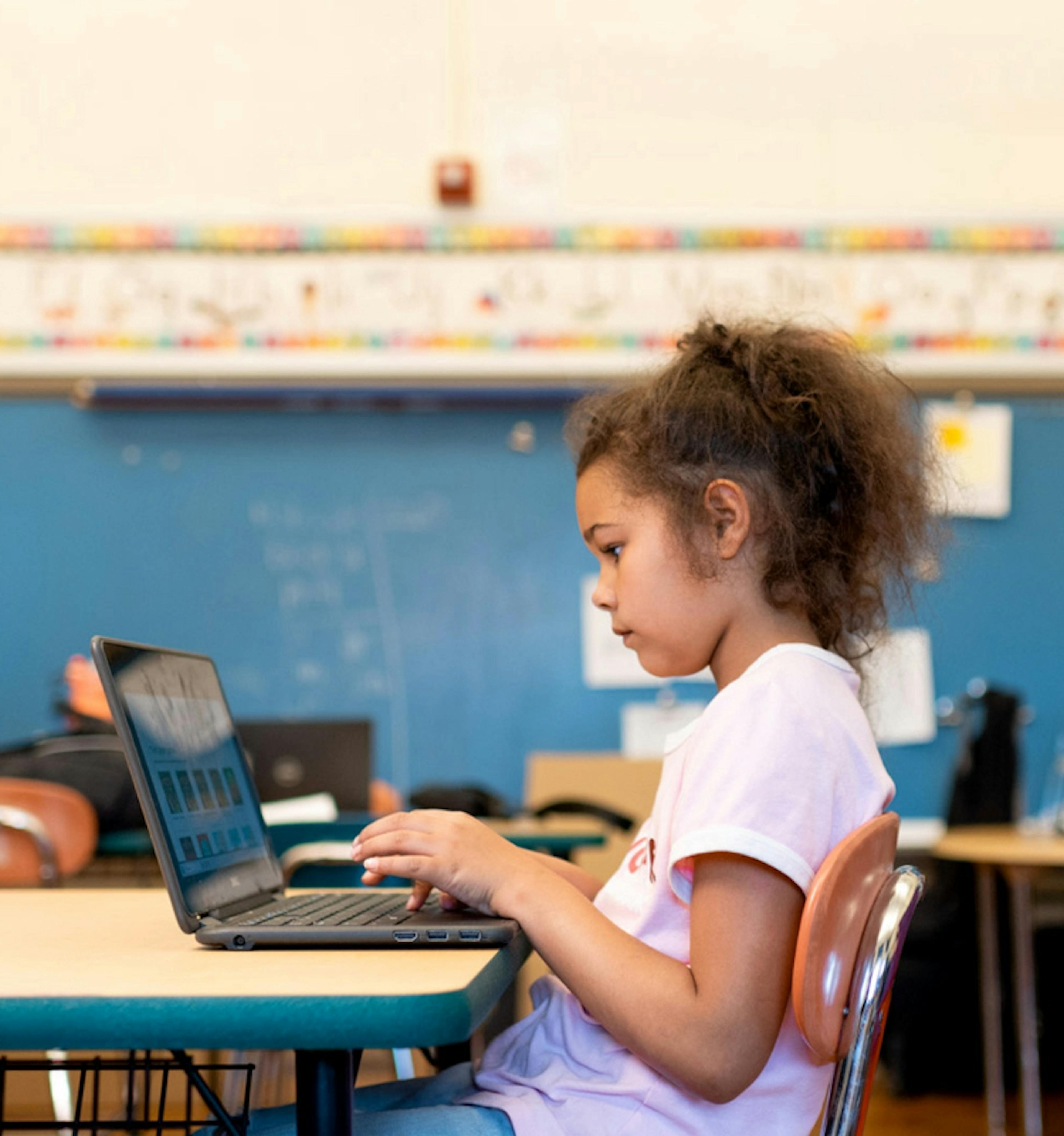 Student working on a laptop in a classroom