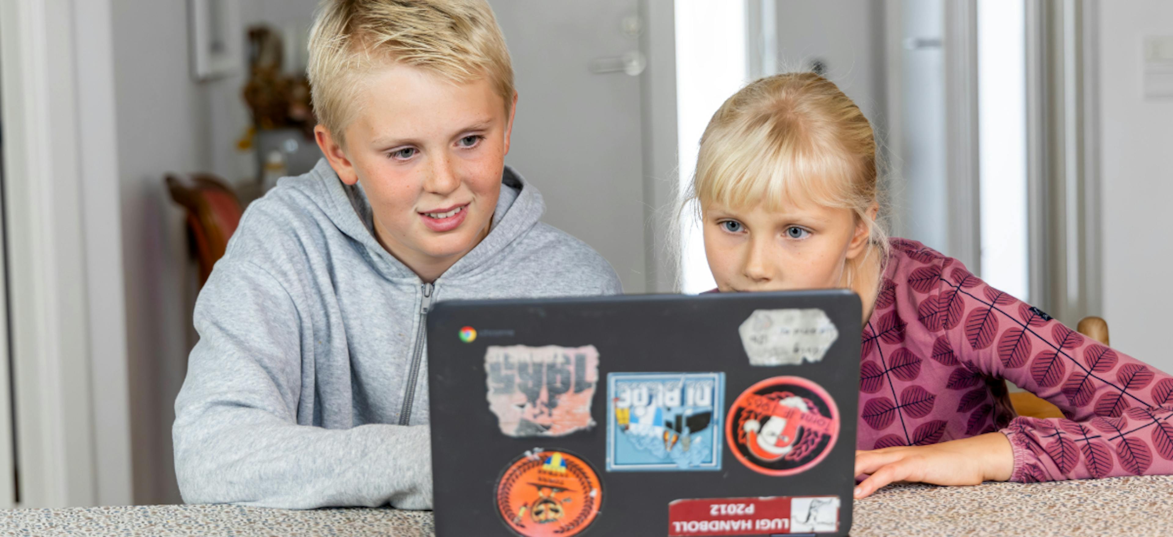 Two students working on a laptop