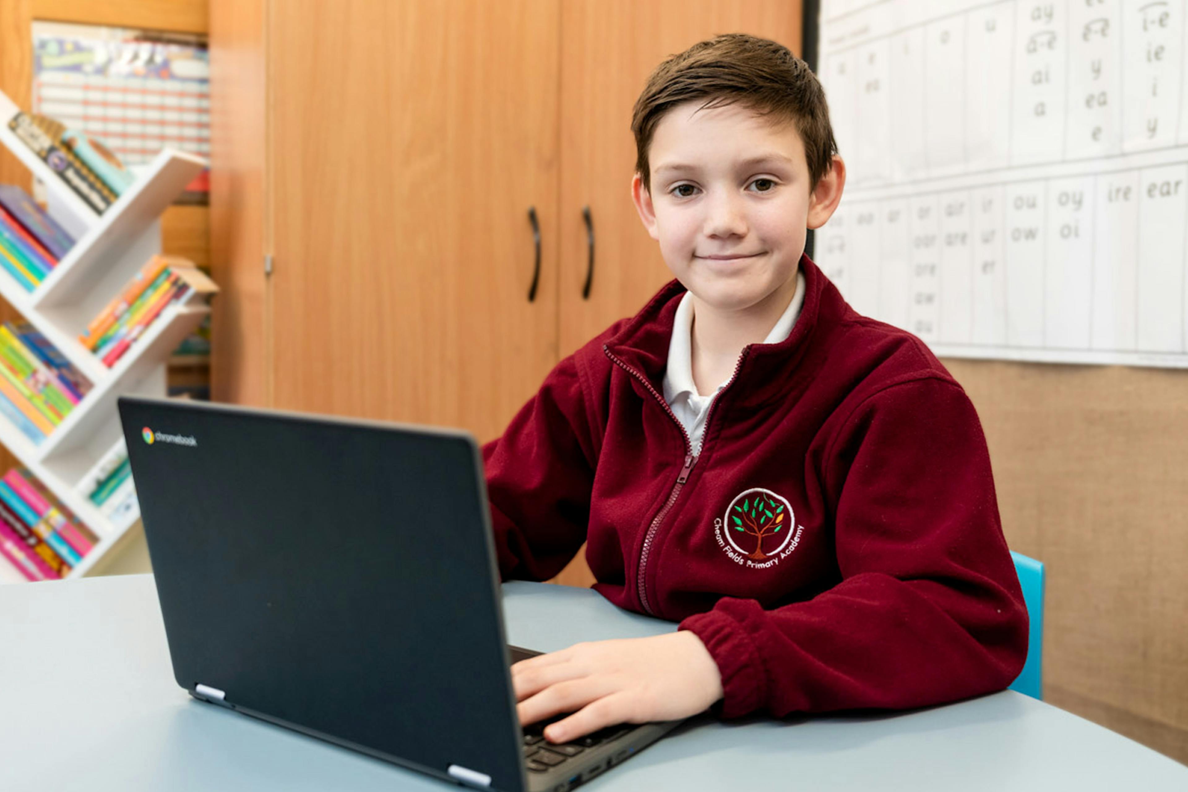 A student at Cheam Fields Primary Academy working on a laptop