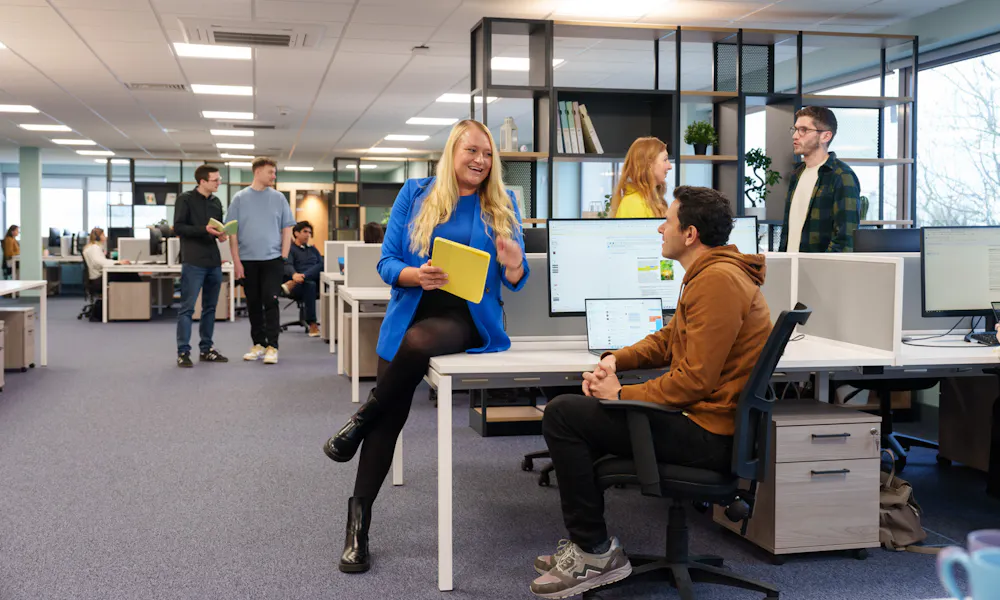 Group of employees chatting in an office space