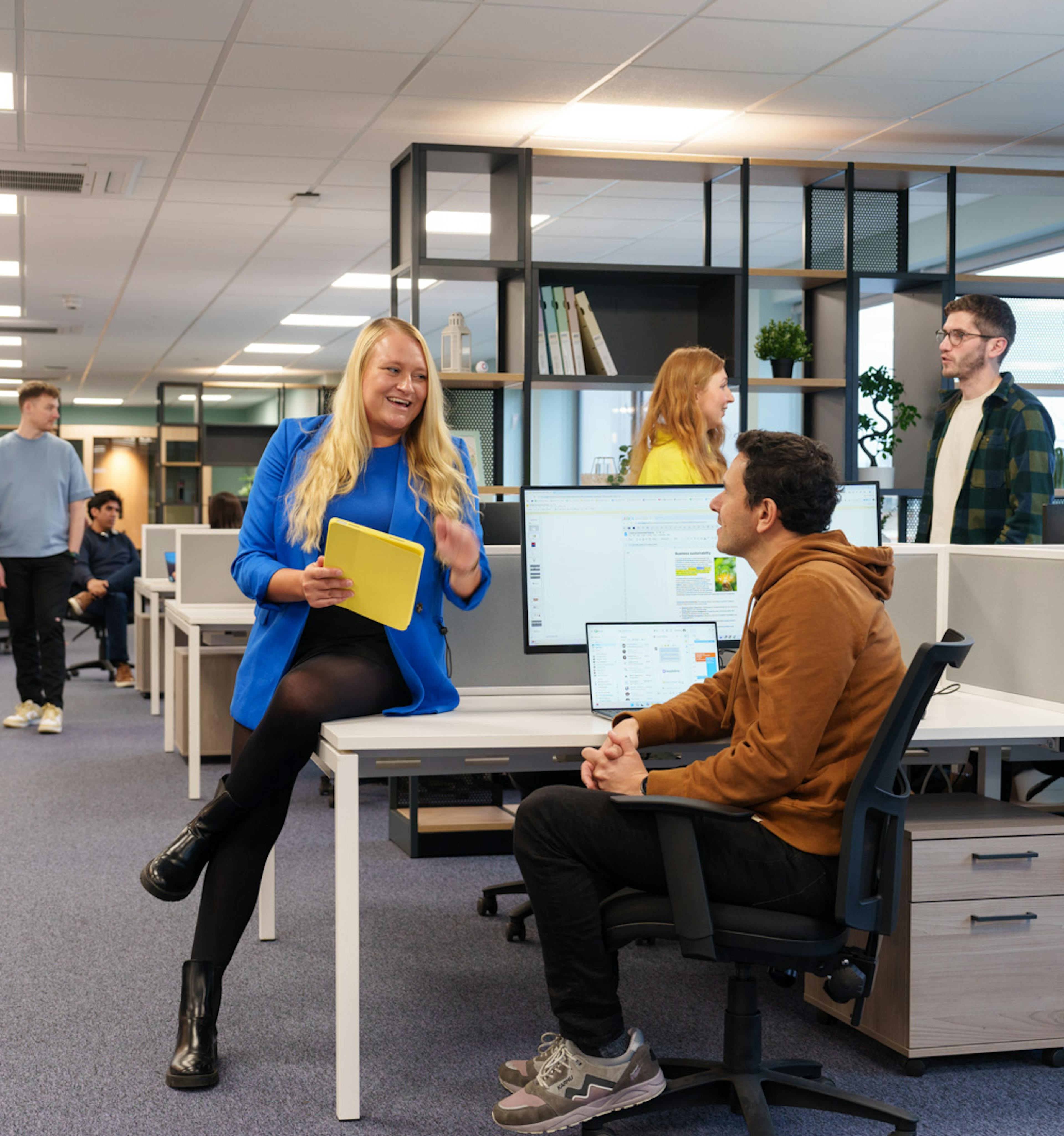 Group of employees chatting in an office space