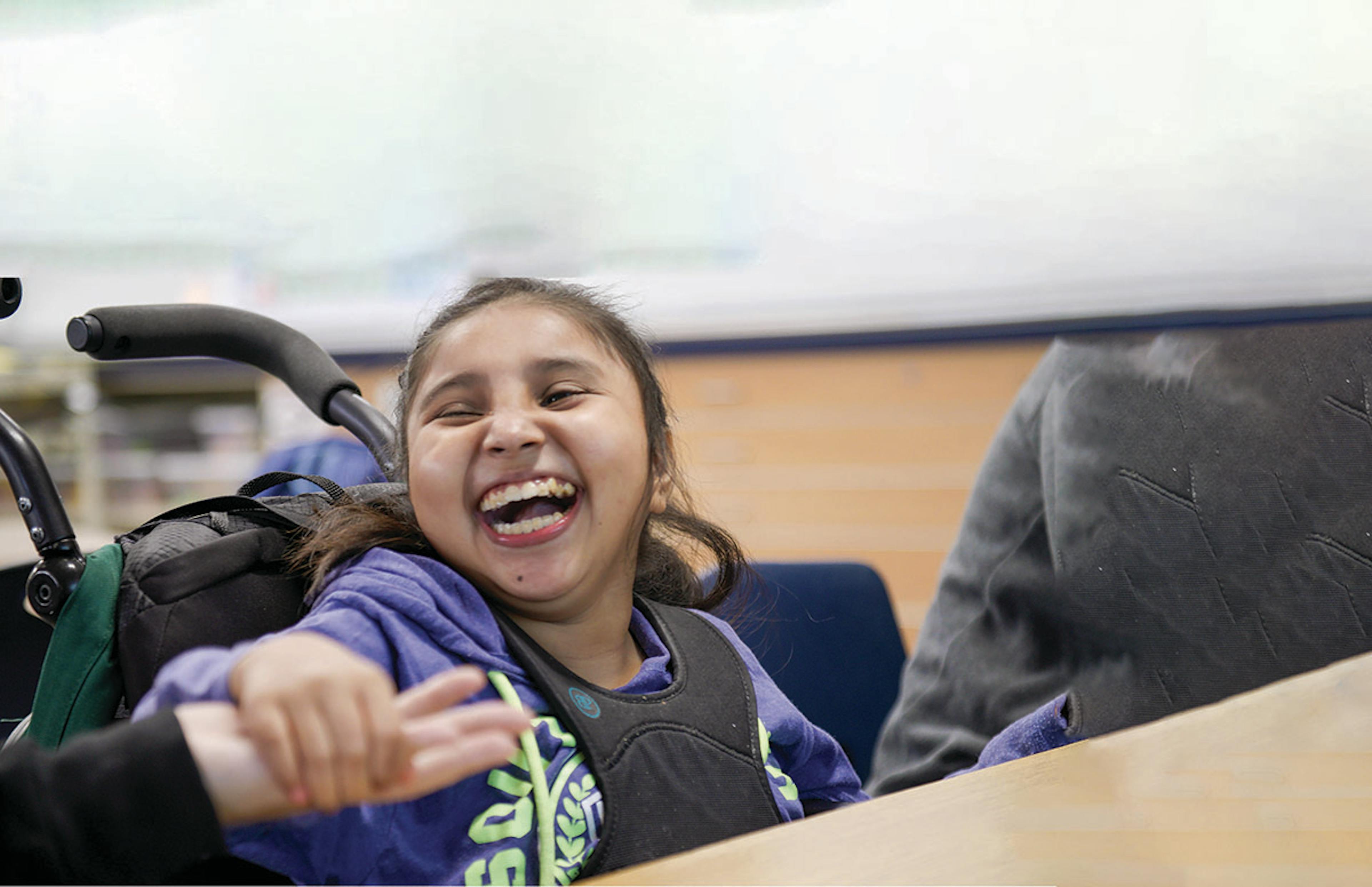Student smiling holding hands