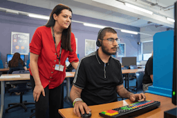 Exams officer with student during an exam.