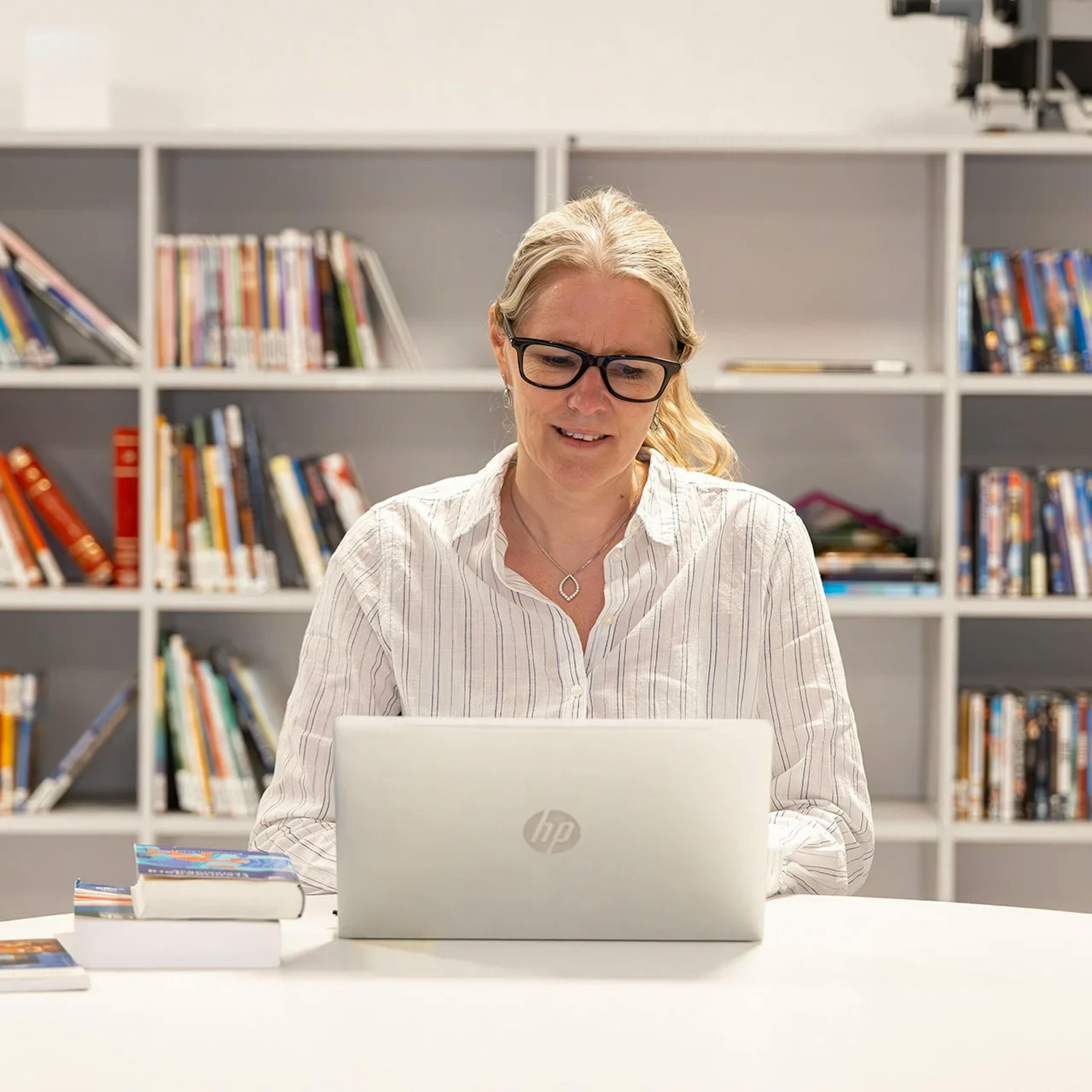 A teacher using a laptop