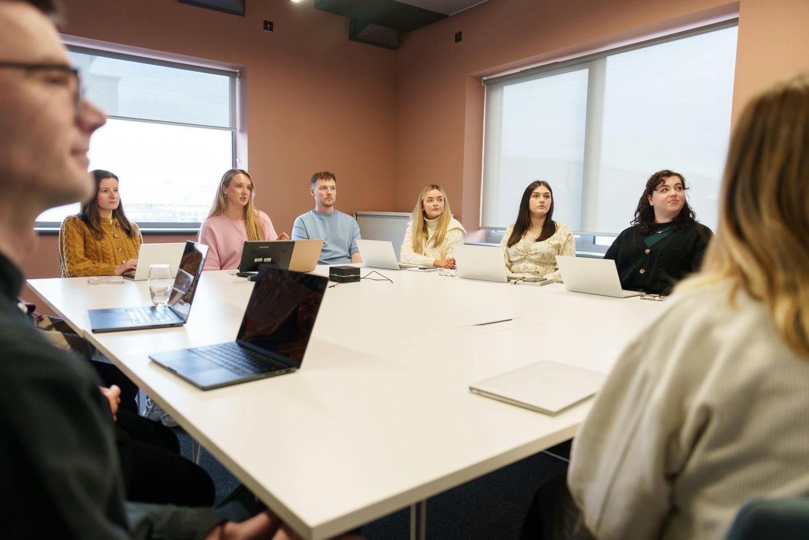 A diverse group of employees gathered around a table in an office