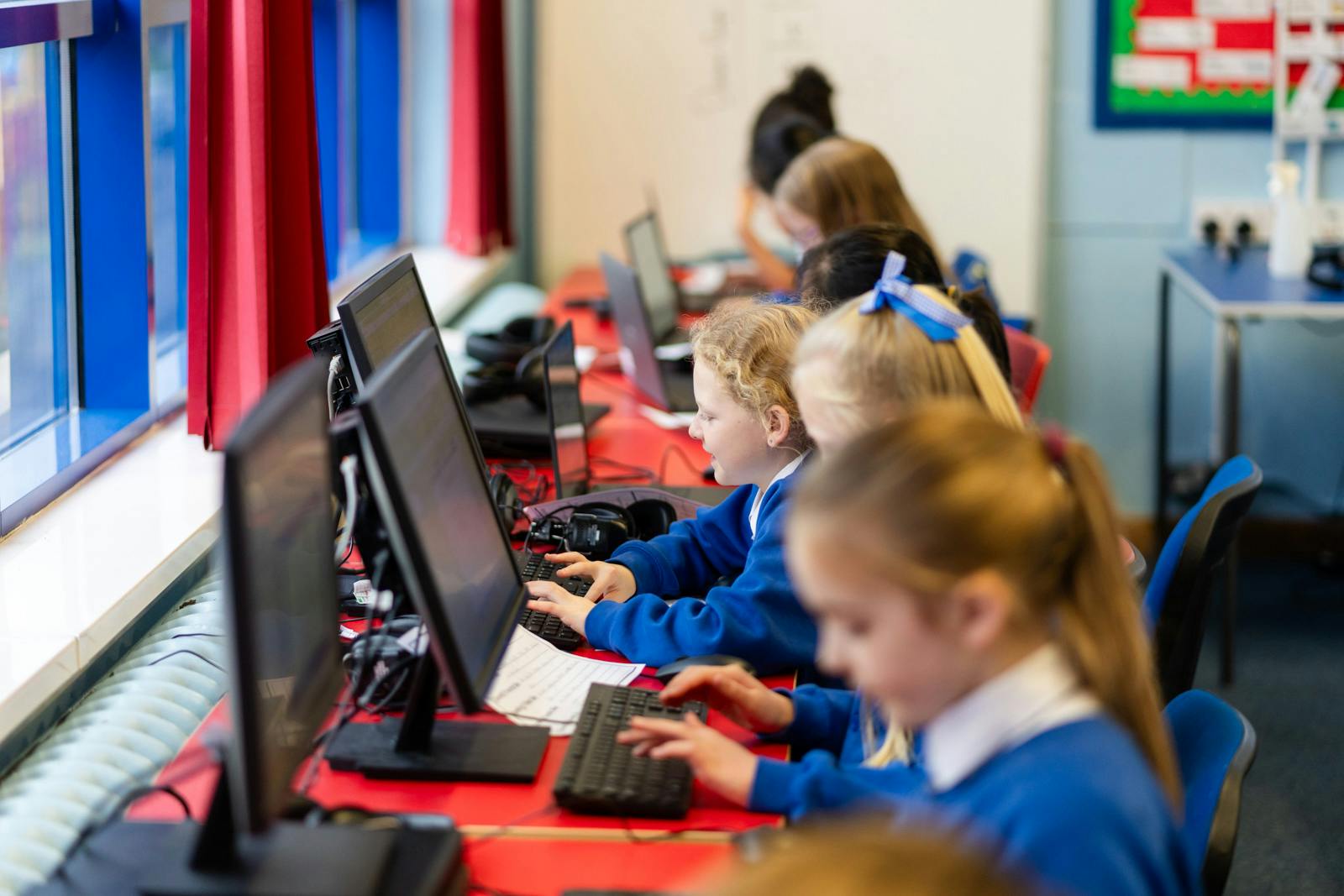 A classroom of young students using laptops