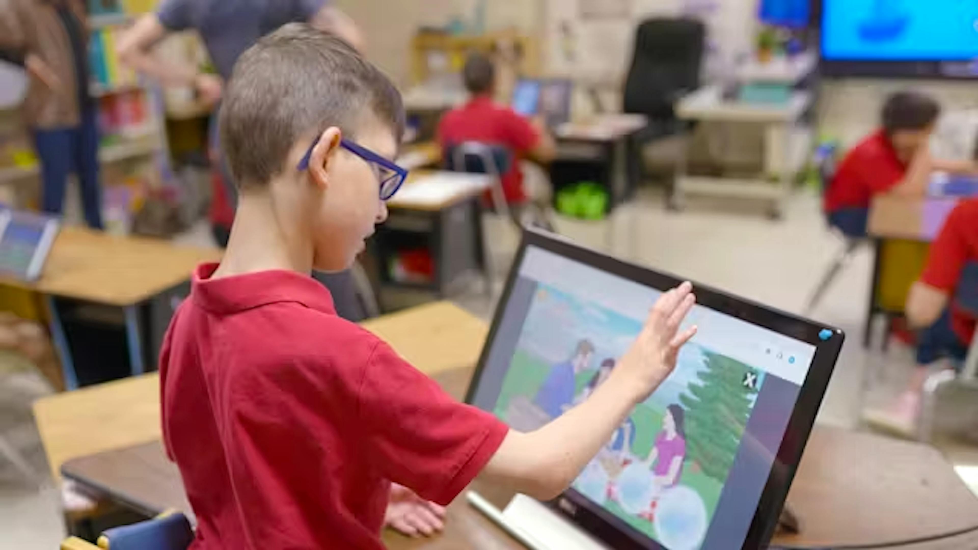 Student playing L3 Skills games on a touch screen