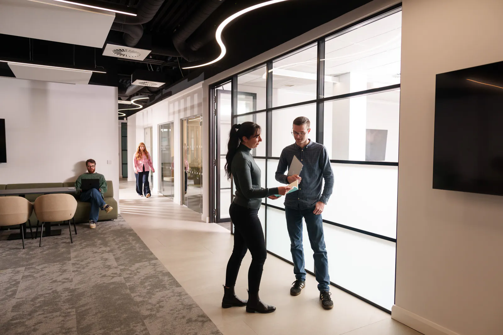 employees standing in an office hallway