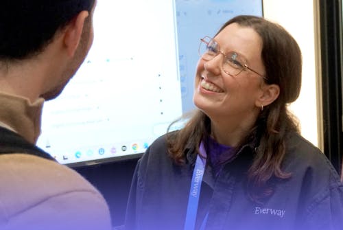 An Everway employee smiling and speaking with a customer at and event
