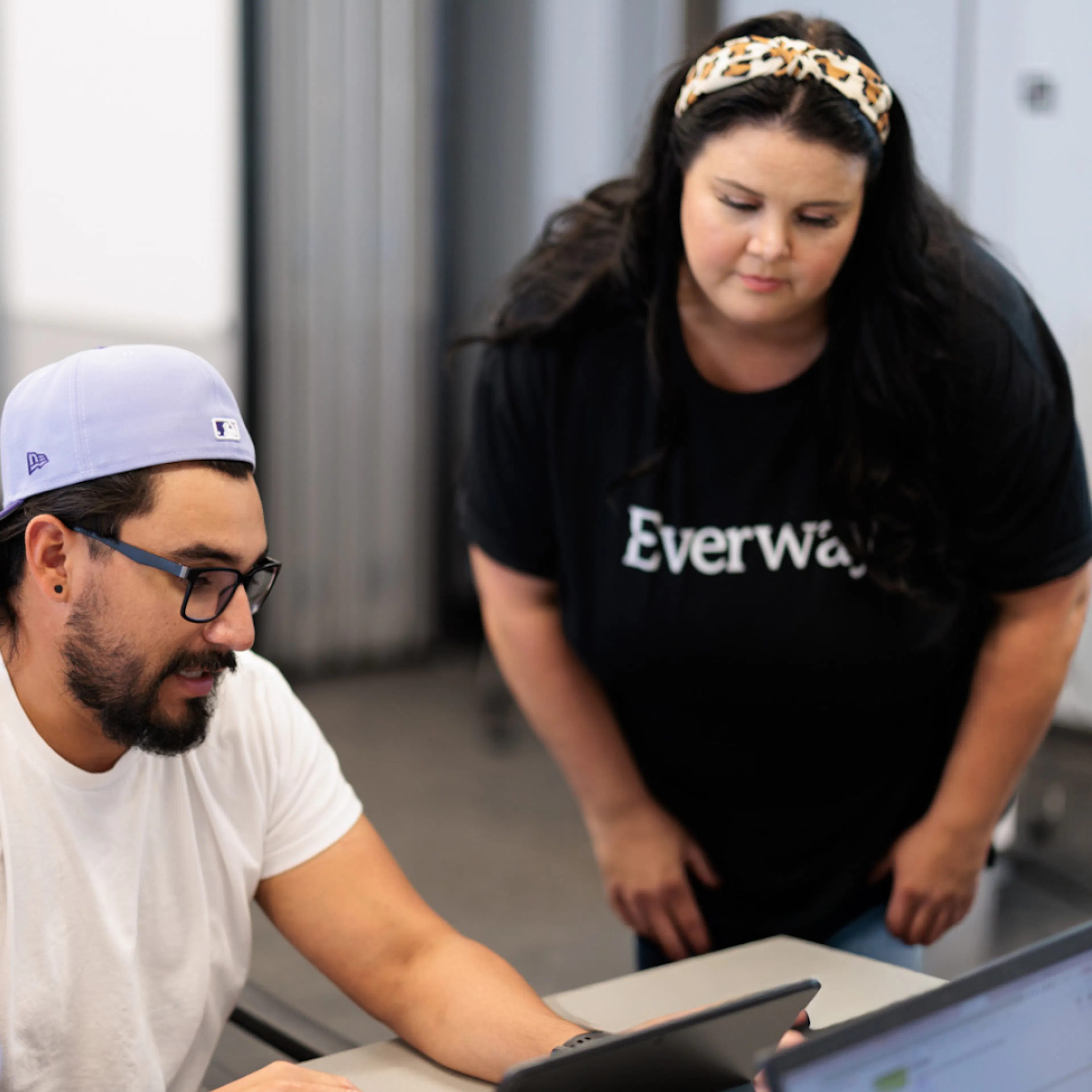 An Everway Employee working alongside a customer to demonstrate a product feature