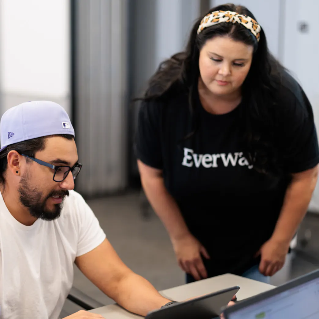 An Everway Employee working alongside a customer to demonstrate a product feature
