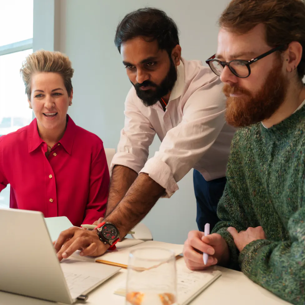 Three colleague working together on a laptop