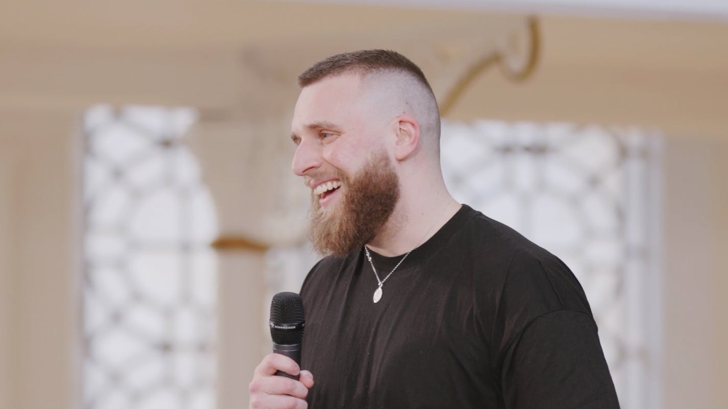 A screen capture of Joshua Luke Smith's talk. He is smiling towards the audience. 