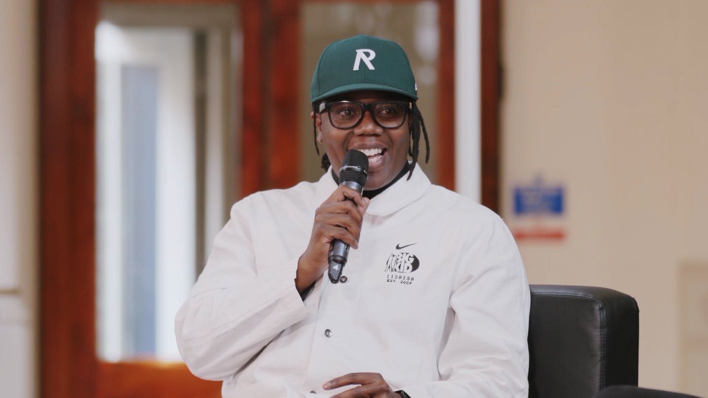A screen capture of Shaninga Marasha's interview. He is laughing at a joke.