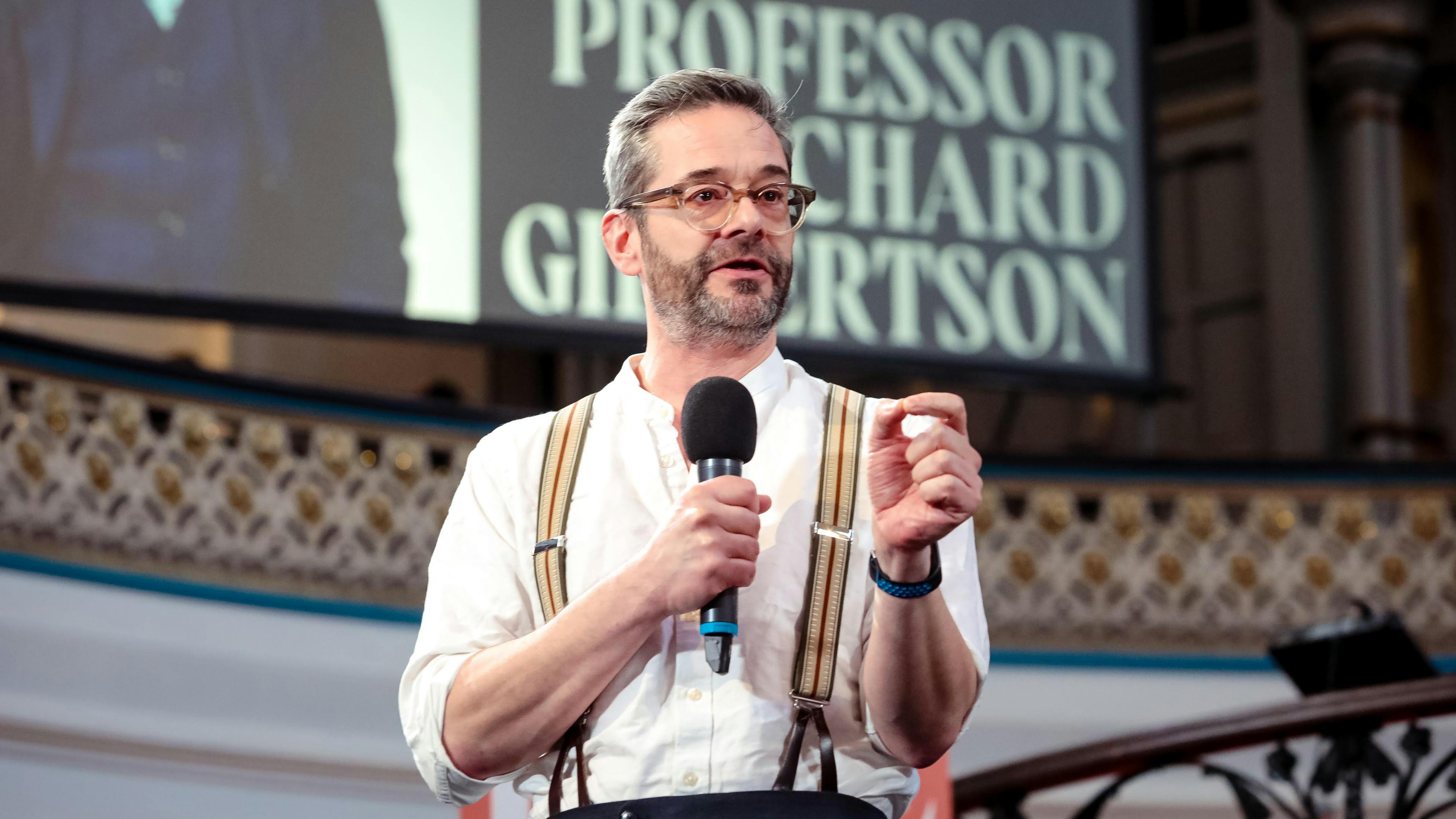 Professor Richard Gilbertson speaking on a stage.