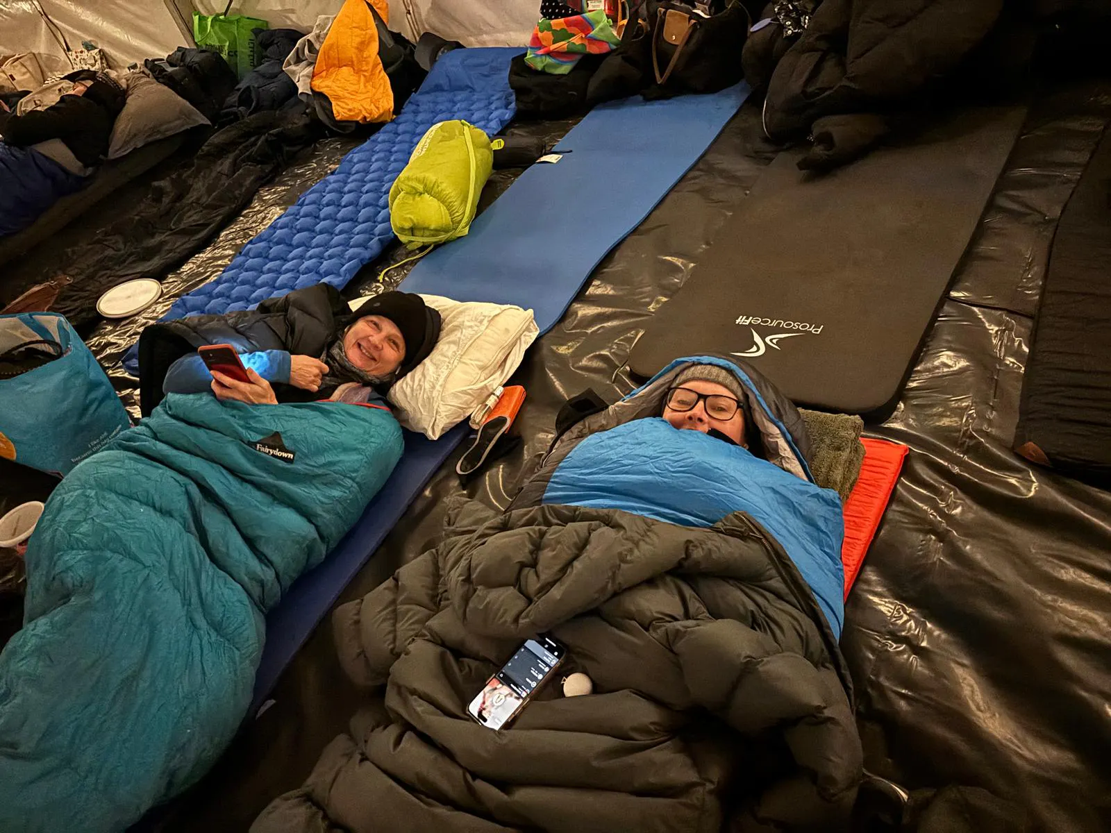 Participants lying in sleeping bags inside a marquee during a charity sleep out.