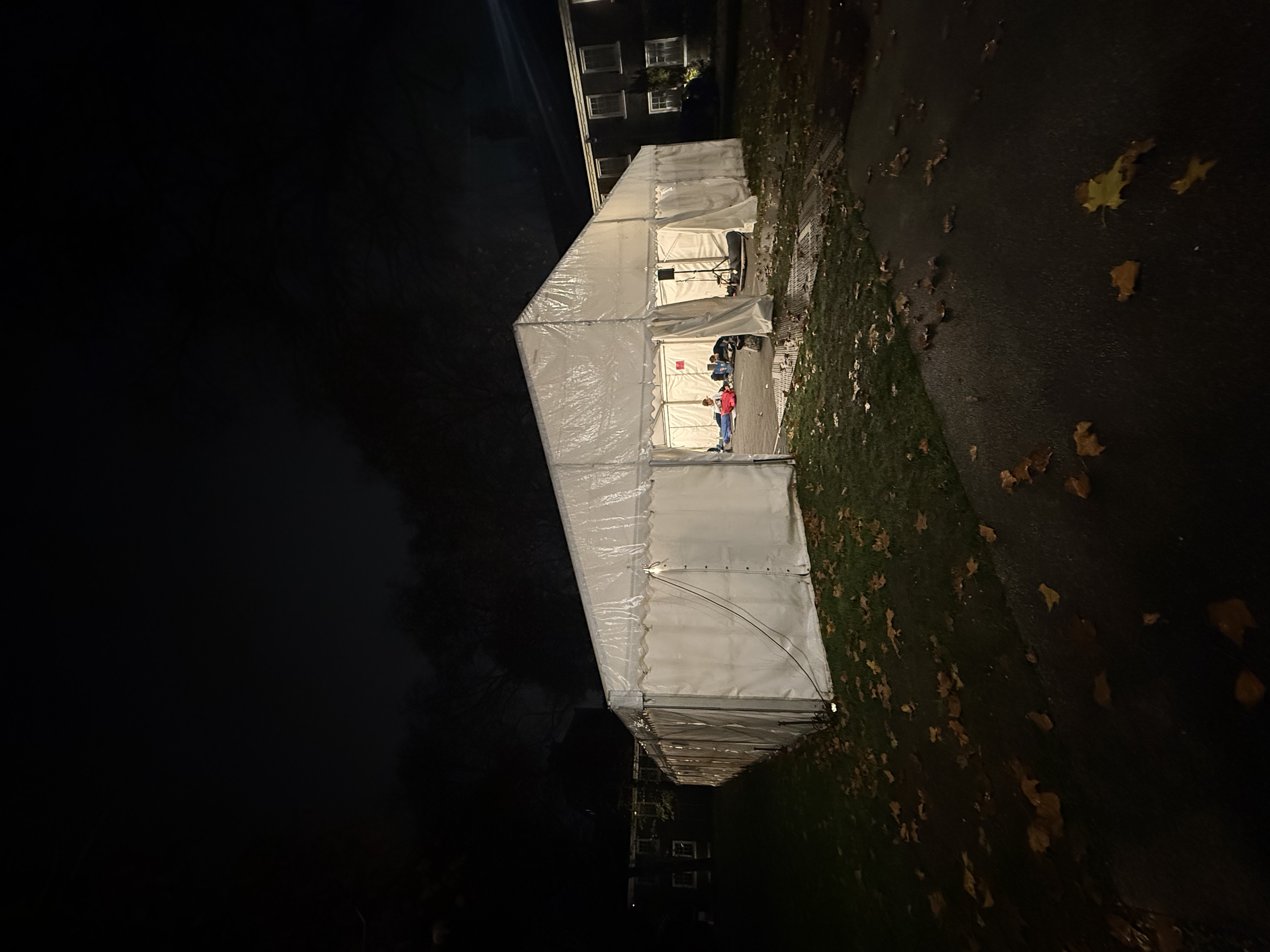 Exterior view of a marquee lit at night, set up for the charity sleep out event.