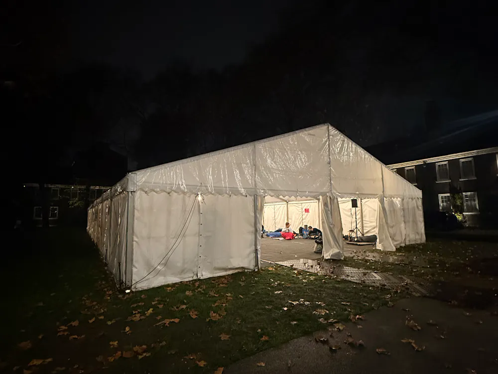 Exterior view of a marquee lit at night, set up for the charity sleep out event.