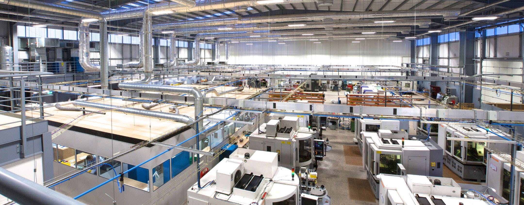 Inside the Exactaform facility, machines and working areas are shown.