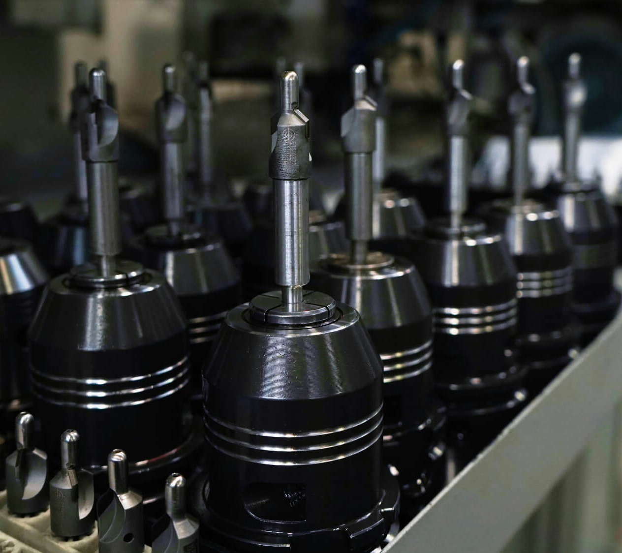 A metal tray containing multiple drill bits