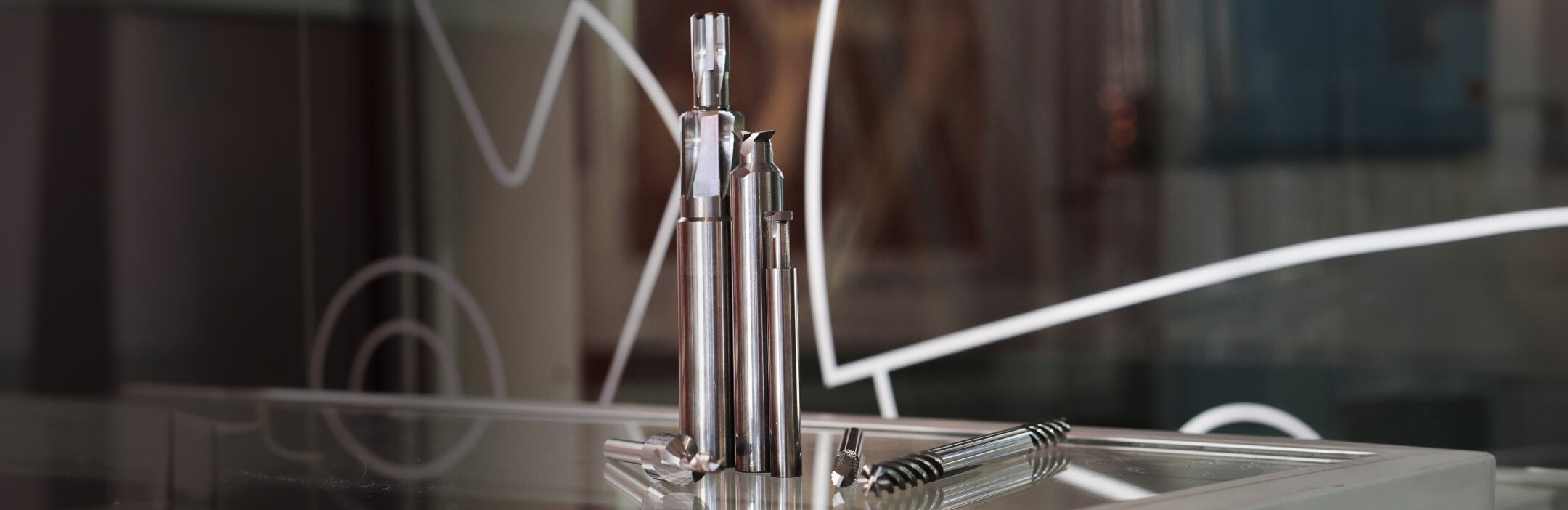 Banner showing cutting tools in front of a glass pane