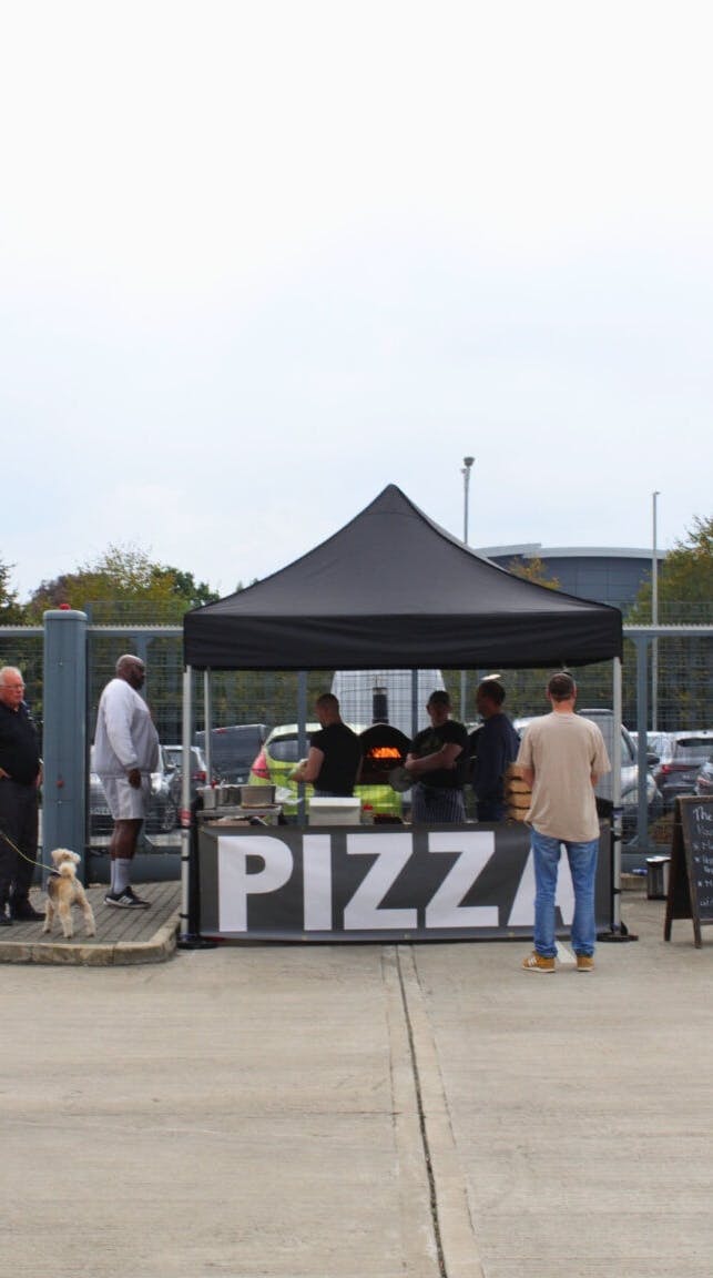 A photo from the Exactaform family day showing people at a food stall.