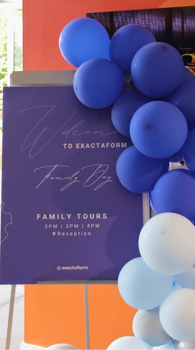 A photo of the welcome banner and balloons at the Exactaform family day.