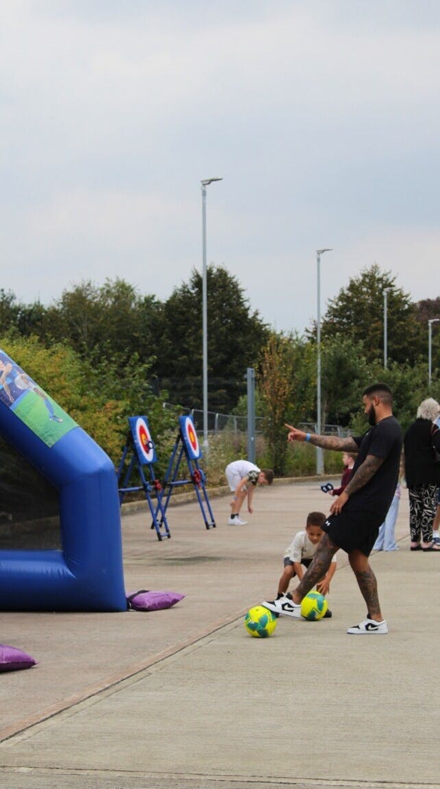 A photo from the Exactaform Family Day showing a man and a child playing a game.