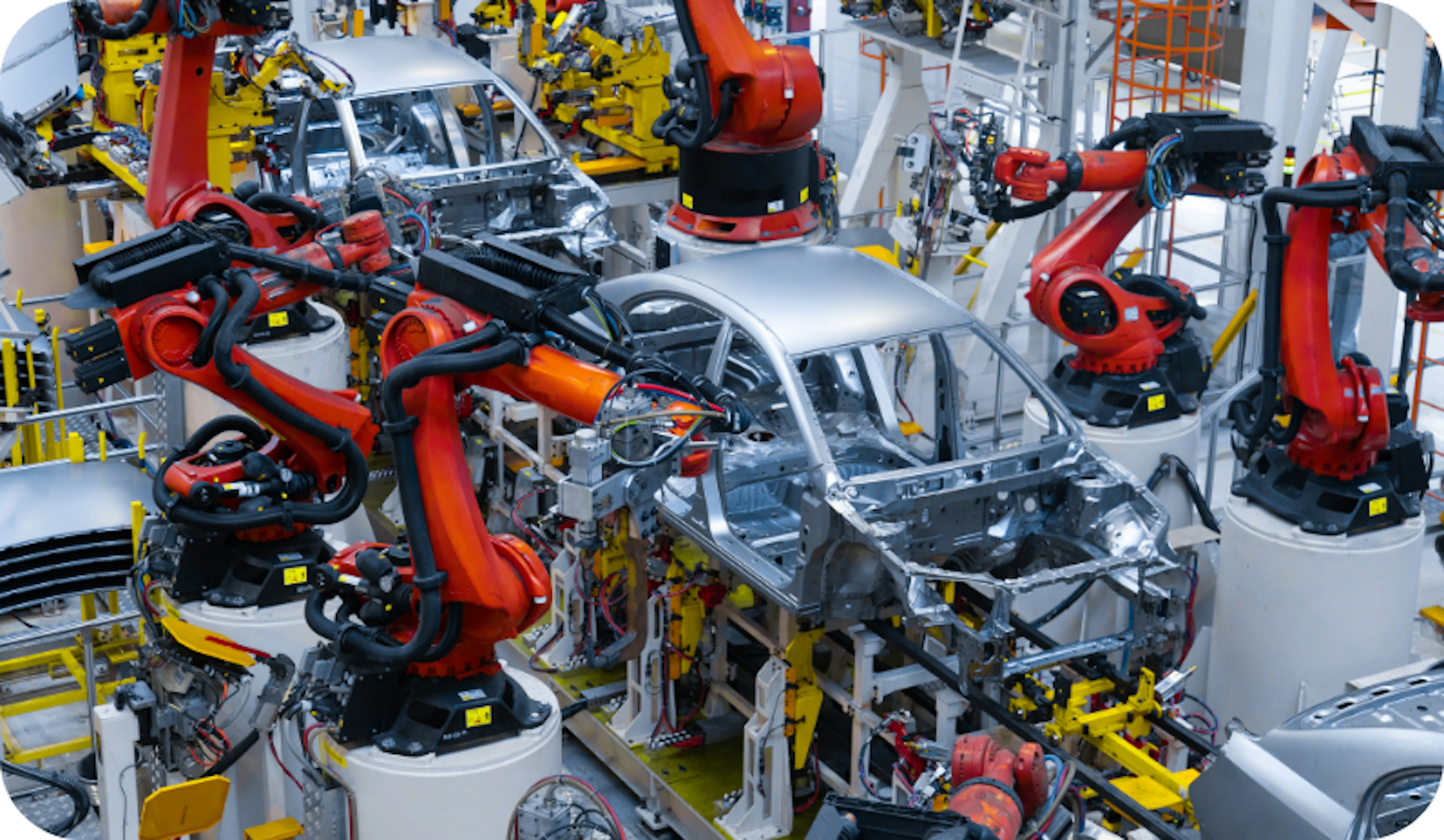 A car factory with cars being built.