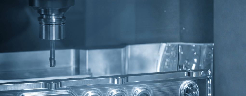 Carbide cutting tool machining a precision metal component on a CNC machine