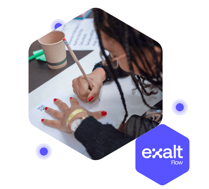 A person drawing on a sheet of paper, with the Exalt Flow logo beside them.