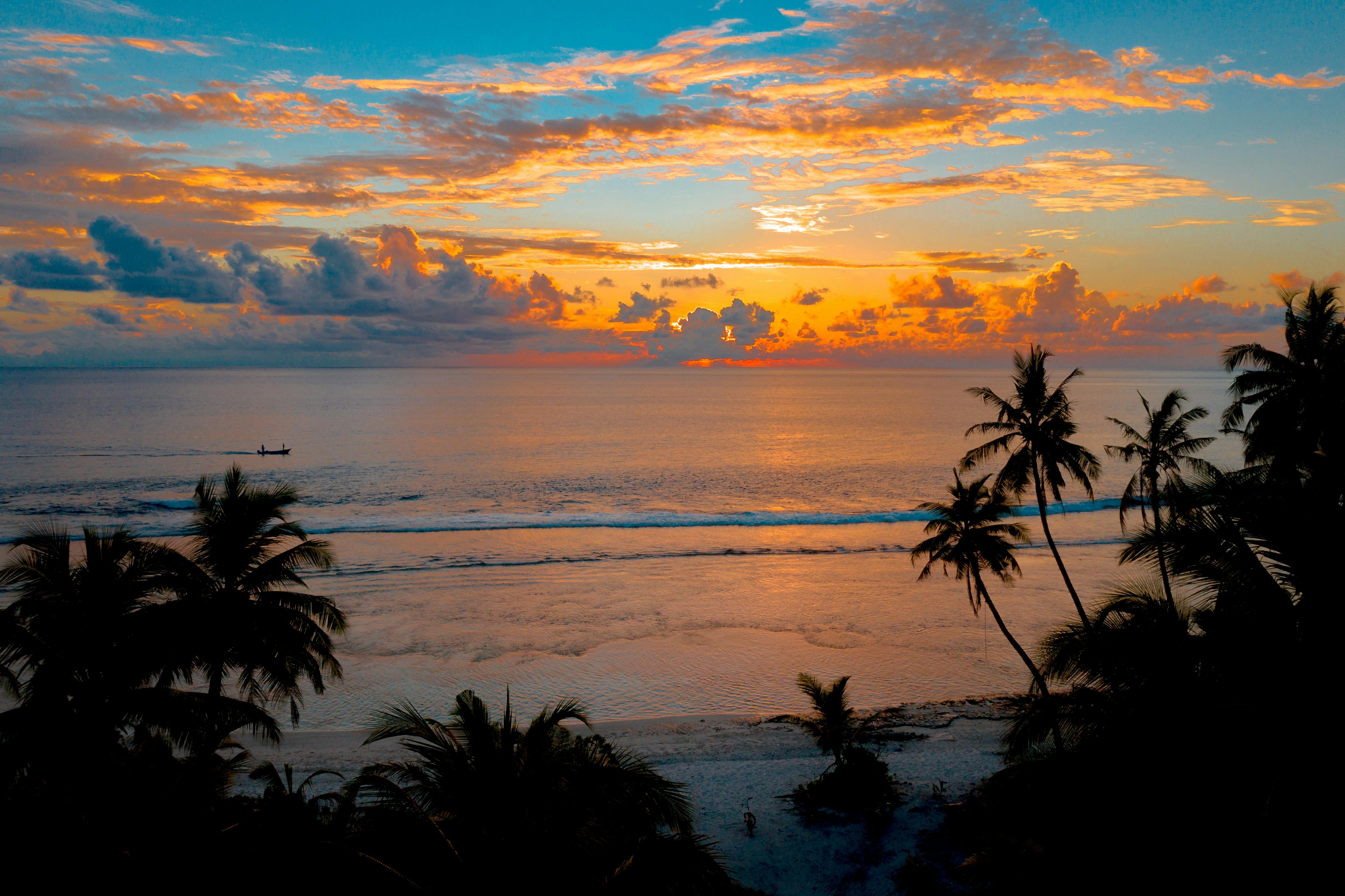 Island sunset over ocean.