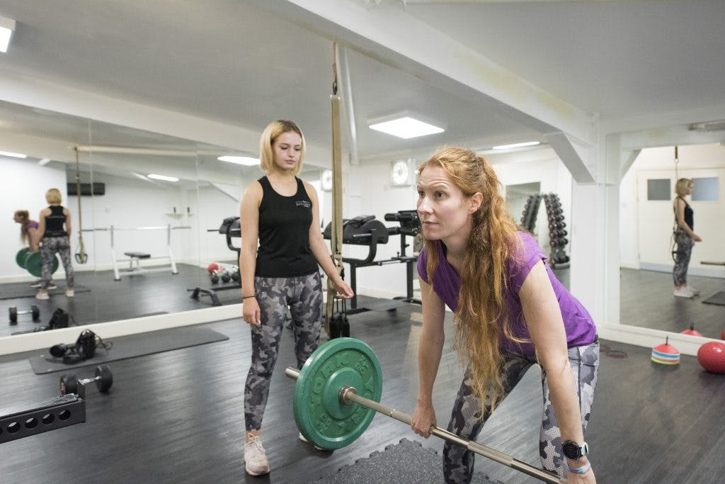 Woman with personal trainer in gym