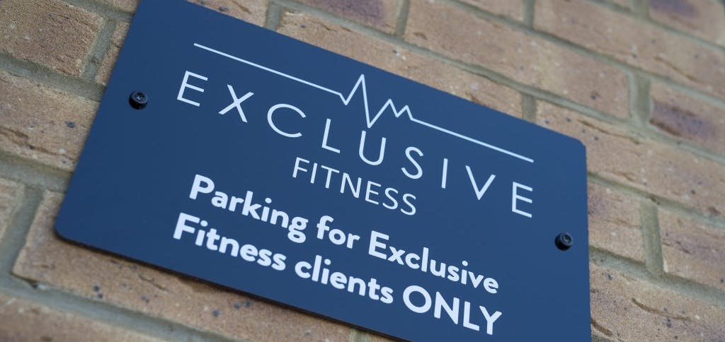 Exclusive fitness exterior parking sign
