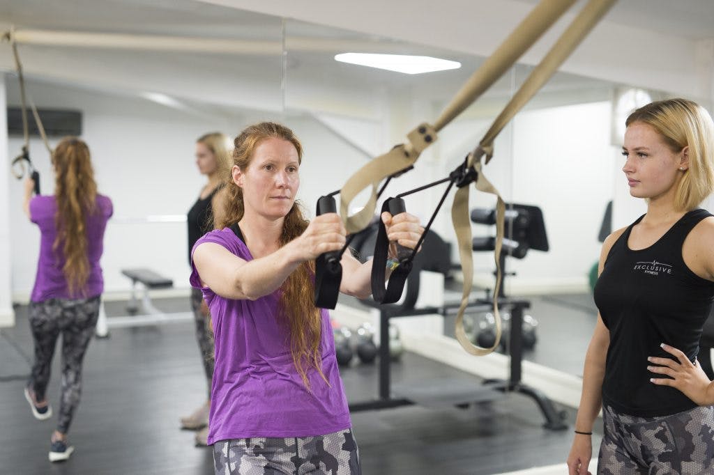 Woman with TRX equipment