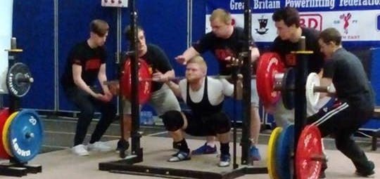 Man Squatting under barbell