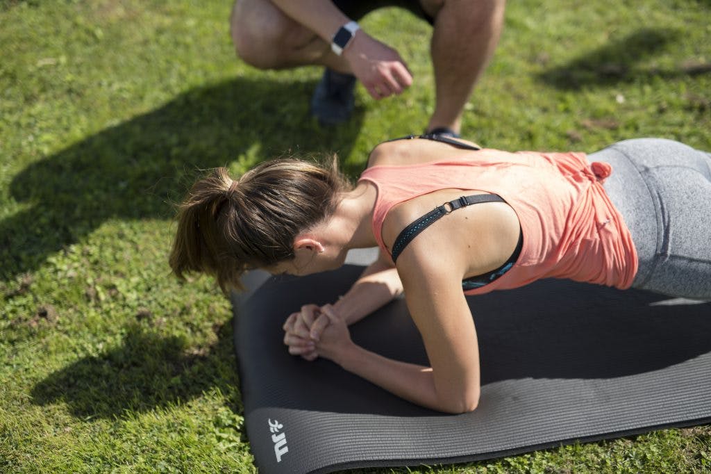 A young girl in plank position