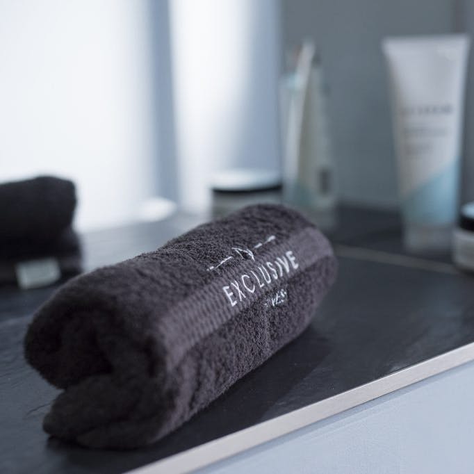 An exclusive fitness towel rolled up and neatly place on a table