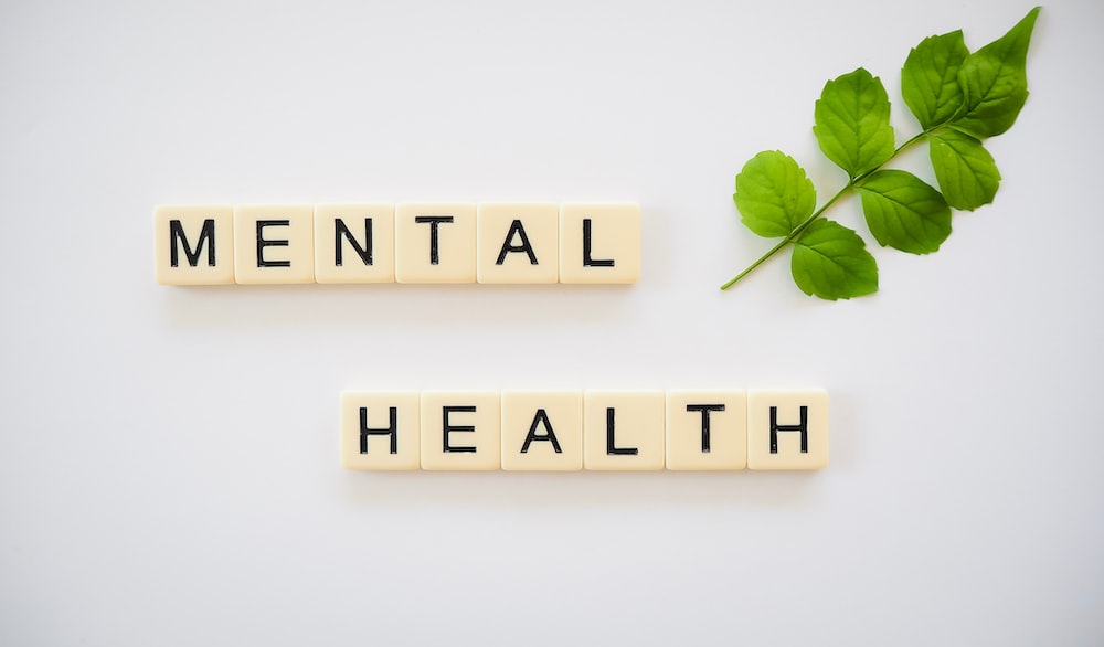 Scrabble style tiles spelling out Mental Health