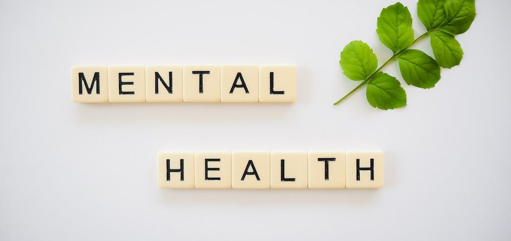 Scrabble style tiles spelling out Mental Health