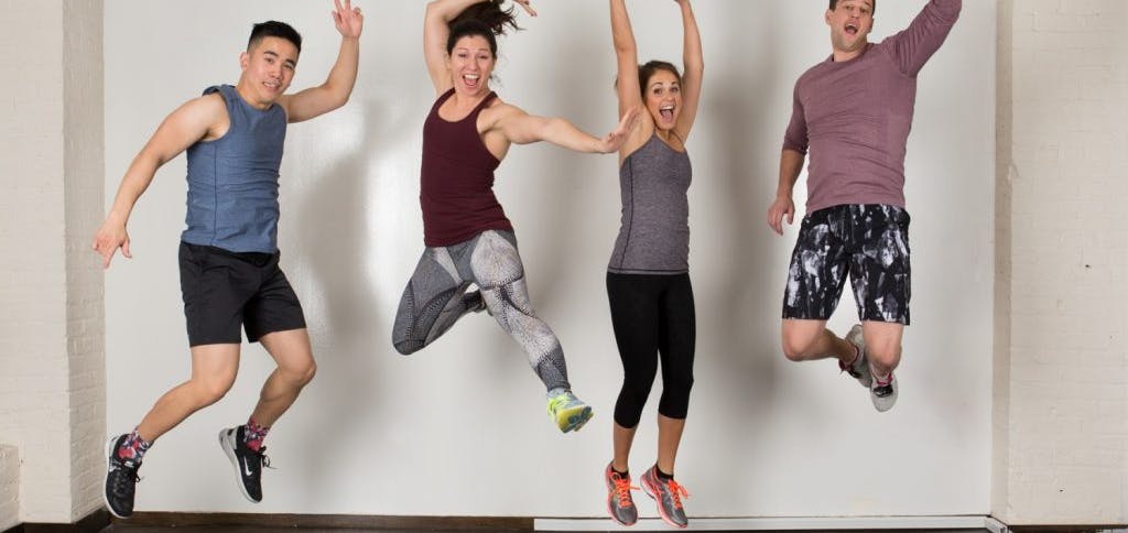 People in fitness clothing leaping into the air
